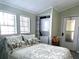 Cozy bedroom features a bed, windows, and a stacked washer and dryer for convenience at 3333 26Th E Ave # 1220, Bradenton, FL 34208