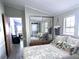 A bedroom that has a sliding mirror closet door and a stacked washer and dryer at 3333 26Th E Ave # 1220, Bradenton, FL 34208