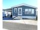 Charming blue single-Gathering home featuring a carport, well-maintained landscaping, and a welcoming entrance at 3333 26Th E Ave # 1220, Bradenton, FL 34208