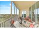Outdoor balcony featuring comfortable seating, offering serene water views and sunny skies at 3603 N Point Rd # 702, Osprey, FL 34229