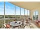 Relaxing screened balcony with seating area offering tranquil water and landscape vistas at 3603 N Point Rd # 702, Osprey, FL 34229