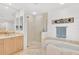 Well-appointed bathroom featuring a soaking tub, glass shower, and ample vanity storage at 3603 N Point Rd # 702, Osprey, FL 34229