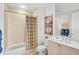 Well-lit bathroom with tiled shower, vanity, toilet, and decorative artwork at 3603 N Point Rd # 702, Osprey, FL 34229