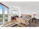 Inviting bedroom featuring hardwood floors, balcony access, and beautiful water views at 3603 N Point Rd # 702, Osprey, FL 34229
