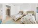 Comfortable bedroom with twin beds and ensuite bathroom with tiled shower at 3603 N Point Rd # 702, Osprey, FL 34229