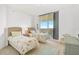 Cozy bedroom featuring twin beds and a sliding glass door to a private balcony at 3603 N Point Rd # 702, Osprey, FL 34229
