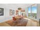 Bright dining room with large windows offering stunning views and a modern chandelier at 3603 N Point Rd # 702, Osprey, FL 34229