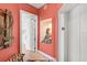 Hallway with decorative niche and artwork leading to a unit entrance and elevator at 3603 N Point Rd # 702, Osprey, FL 34229