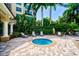 Relaxing hot tub area with comfortable seating, surrounded by lush tropical landscaping at 3603 N Point Rd # 702, Osprey, FL 34229