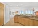 Open concept kitchen with wood cabinets, granite countertops, and stainless steel appliances at 3603 N Point Rd # 702, Osprey, FL 34229