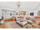 Bright living room with a cozy seating area and partial view of the kitchen at 3603 N Point Rd # 702, Osprey, FL 34229