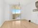 Bright living room featuring light hardwood floors and balcony access with scenic views at 3603 N Point Rd # 702, Osprey, FL 34229