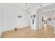 Spacious living room with light hardwood floors leading to other rooms, and modern lighting at 3603 N Point Rd # 702, Osprey, FL 34229
