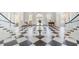 Elegant lobby with black and white marble floors, columns, and grand piano at 3603 N Point Rd # 702, Osprey, FL 34229