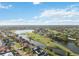 Aerial view showing homes along the water and a section of the golf course at 3876 Torrey Pines Blvd, Sarasota, FL 34238