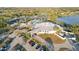 Overhead of a magnificent clubhouse, a sparking pool, and several pristine tennis courts at 3876 Torrey Pines Blvd, Sarasota, FL 34238