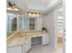 Bathroom with a vanity area, large mirror, and a separate bathtub at 3876 Torrey Pines Blvd, Sarasota, FL 34238