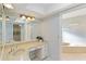 Bathroom featuring a vanity, large mirror, and views of a soaking tub at 3876 Torrey Pines Blvd, Sarasota, FL 34238