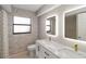 Modern bathroom featuring double sinks, granite counters, and updated fixtures at 3876 Torrey Pines Blvd, Sarasota, FL 34238