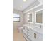 Updated bathroom with granite counters, double sinks, and stylish lighting at 3876 Torrey Pines Blvd, Sarasota, FL 34238