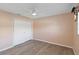 Charming bedroom featuring updated flooring, closet, and ceiling fan at 3876 Torrey Pines Blvd, Sarasota, FL 34238