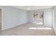 Neutral bedroom featuring carpet and a view to a tiled area through an interior window at 3876 Torrey Pines Blvd, Sarasota, FL 34238