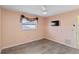 Cozy bedroom featuring updated flooring, ceiling fan, and natural light at 3876 Torrey Pines Blvd, Sarasota, FL 34238