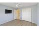 Bright bedroom with ceiling fan, wood-look floors, and closet space at 3876 Torrey Pines Blvd, Sarasota, FL 34238