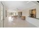 Open dining and kitchen area with tiled floors and abundant natural light from surrounding windows at 3876 Torrey Pines Blvd, Sarasota, FL 34238