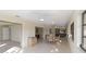 Spacious dining area with tile flooring and windows, adjacent to a living room at 3876 Torrey Pines Blvd, Sarasota, FL 34238
