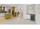 Bright, white kitchen with a yellow-green island, tiled backsplash, and stainless steel appliances at 3876 Torrey Pines Blvd, Sarasota, FL 34238
