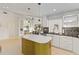 Bright kitchen with a yellow-green island, white cabinets, and open access to the living area at 3876 Torrey Pines Blvd, Sarasota, FL 34238