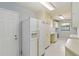 Large laundry room area with appliances, sink, and storage at 3876 Torrey Pines Blvd, Sarasota, FL 34238