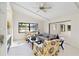 Inviting living room featuring tile floors, a vaulted ceiling, a fireplace, and lots of natural light at 3876 Torrey Pines Blvd, Sarasota, FL 34238