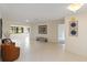 Bright living room with neutral walls, tile floors, and lots of natural light at 3876 Torrey Pines Blvd, Sarasota, FL 34238