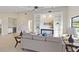 Bright living room with vaulted ceiling, fireplace, tile floor, and modern furnishings at 3876 Torrey Pines Blvd, Sarasota, FL 34238