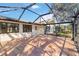 Enclosed patio featuring tile flooring and a metal frame screen providing a relaxed outdoor living space at 3876 Torrey Pines Blvd, Sarasota, FL 34238