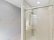 Walk-in shower featuring tiled walls, glass doors, and a chrome showerhead at 3876 Torrey Pines Blvd, Sarasota, FL 34238