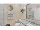 Clean bathroom with a granite countertop, modern fixtures, and a tiled shower with glass doors at 3982 Chatsworth Greene # 37, Sarasota, FL 34235