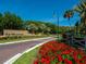 Community entrance featuring manicured landscaping and signage for The Meadows at 3982 Chatsworth Greene # 37, Sarasota, FL 34235