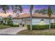 Charming single-story villa featuring a tile roof, brick driveway, and well-manicured landscaping at 3982 Chatsworth Greene # 37, Sarasota, FL 34235