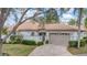 Charming home with a tile roof, brick driveway, and an attached two-car garage at 3982 Chatsworth Greene # 37, Sarasota, FL 34235