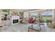 Bright and spacious living room boasting a fireplace, plush seating, and golf course views at 3982 Chatsworth Greene # 37, Sarasota, FL 34235