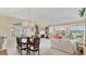 Inviting living space featuring a fireplace, dining area, and abundant natural light at 3982 Chatsworth Greene # 37, Sarasota, FL 34235