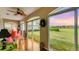 Cozy sunroom with large windows offering scenic backyard views, bright sunlight, and wood flooring at 3982 Chatsworth Greene # 37, Sarasota, FL 34235