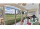 Bright sunroom with large windows offering beautiful views of the lush green lawn at 3982 Chatsworth Greene # 37, Sarasota, FL 34235
