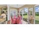 Bright sunroom with a glass table, comfortable chairs, and scenic backyard views at 3982 Chatsworth Greene # 37, Sarasota, FL 34235