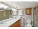 Well-lit bathroom with double sink vanity, ample counter space, and neutral decor at 4021 Barry Way, Sarasota, FL 34232