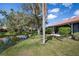 Backyard view featuring mature trees and beautiful pond at 4067 Wilshire E Cir # 131, Sarasota, FL 34238