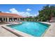 Community swimming pool with crystal-clear water, lounge chairs, and well-maintained surroundings at 4067 Wilshire E Cir # 131, Sarasota, FL 34238